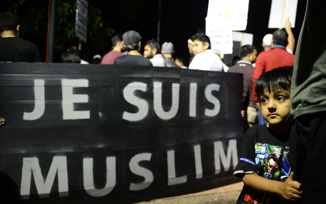 People gather during a rally to protest against negative coverage of Islam and French satirical weekly Charlie Hebdo's caricatures of the Prophet Mohammed, in Sydney.