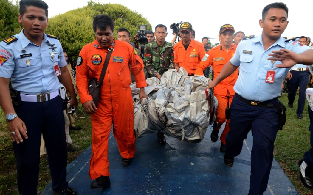Members of the Indonesian air forces carry items retrieved from the Java Sea.