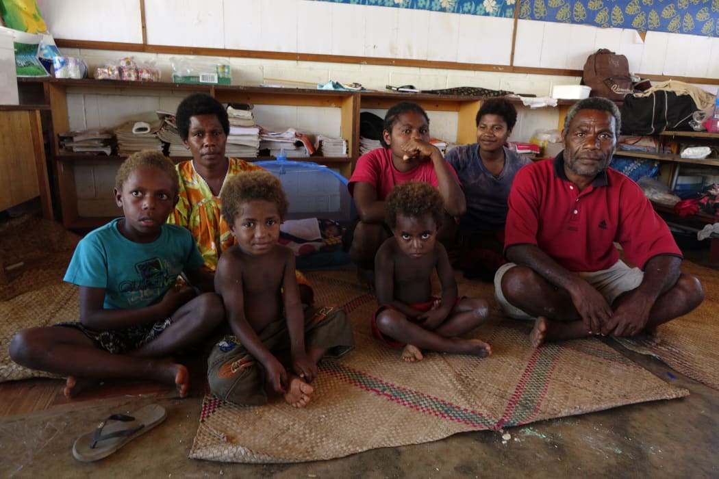 Ralph and Mary Yalu and their family at the Freswota Evacuation Centre. They lost everything in the cyclone but gained a new family member inside the blue mosquito net who was born during the Cyclone. They named her Pamina.