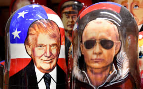 Traditional Russian wooden nesting dolls, Matryoshka dolls, depicting Russia's President Vladimir Putin and US President Donald Trump are displayed for sale in Saint Petersburg on August 7, 2025. The Kremlin said on August 7, 2025 that a milestone summit between Donald Trump and Vladimir Putin to resolve the conflict in Ukraine was set for the "coming days". The Russian leader named the United Arab Emirates (UAE) as a potential location for the Trump summit, but ruled out a meeting with Ukraine's Zelensky as conditions for such weren't met yet. (Photo by Olga MALTSEVA / AFP)