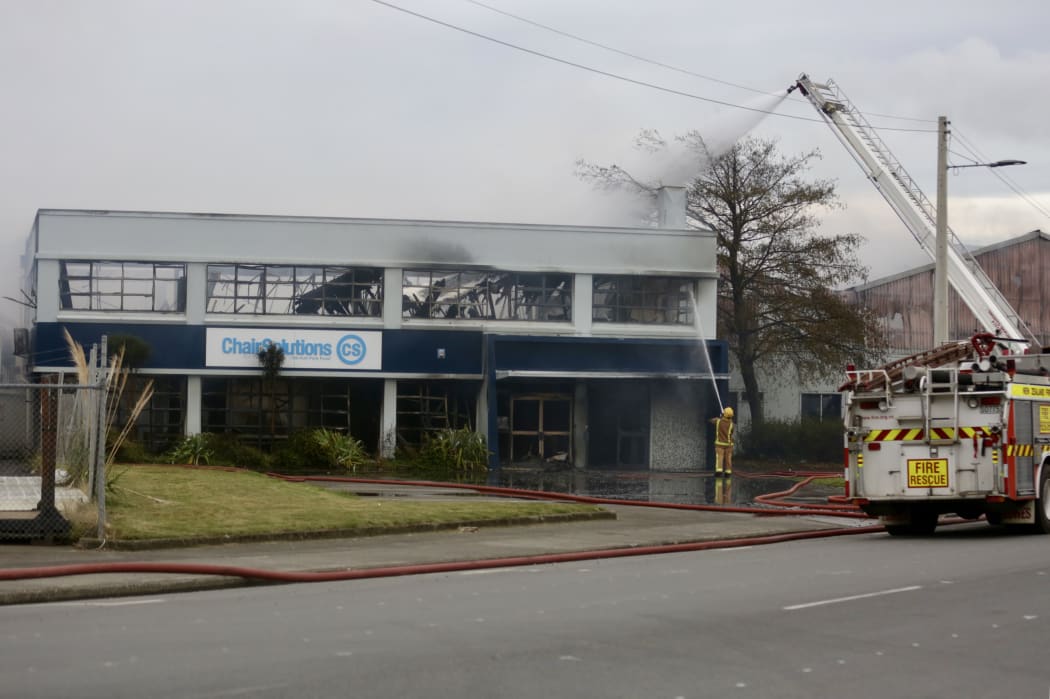 Firefighters tackling the blaze at Chair Solutions on Lower Hutt Park Road.