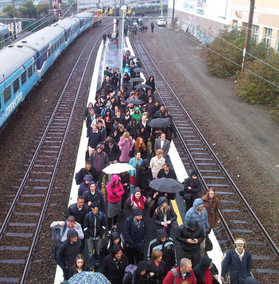Passengers walked from halted trains to the platform at Kaiwharawhara Station.