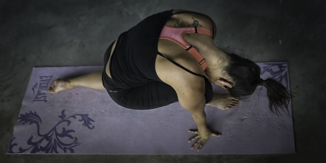 A woman doing yoga.