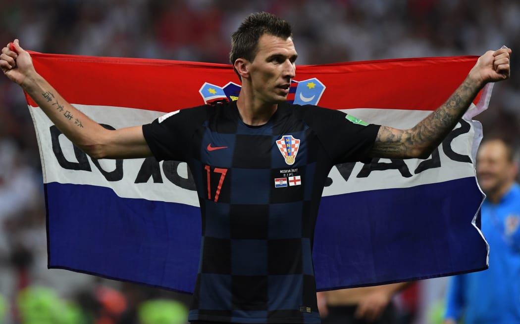 Croatian forward Mario Mandzukic celebrates at the end of the Russia 2018 World Cup semi-final football match against England.
