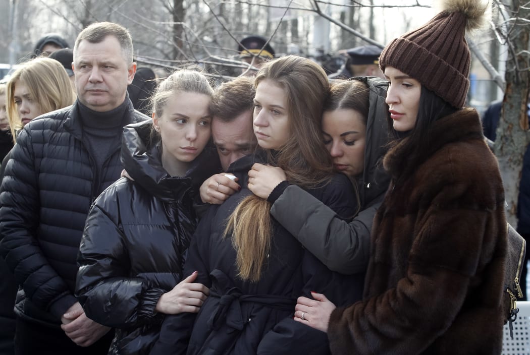 Relatives and friends react during a ceremony of a foundation stone for a future memorial and square to memory the victims of the Ukraine International Airlines flight PS752 plane crash, at the Boryspil International Airport near Kyiv, Ukraine, on 17 February, 2020.