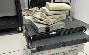 A trolley of 90s internet equipment in a sterile server room