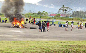 A group of angry residents set tires on fire at Oksibil Airport in Pegunungan Bintang regency, Papua, on November 18, 2017.