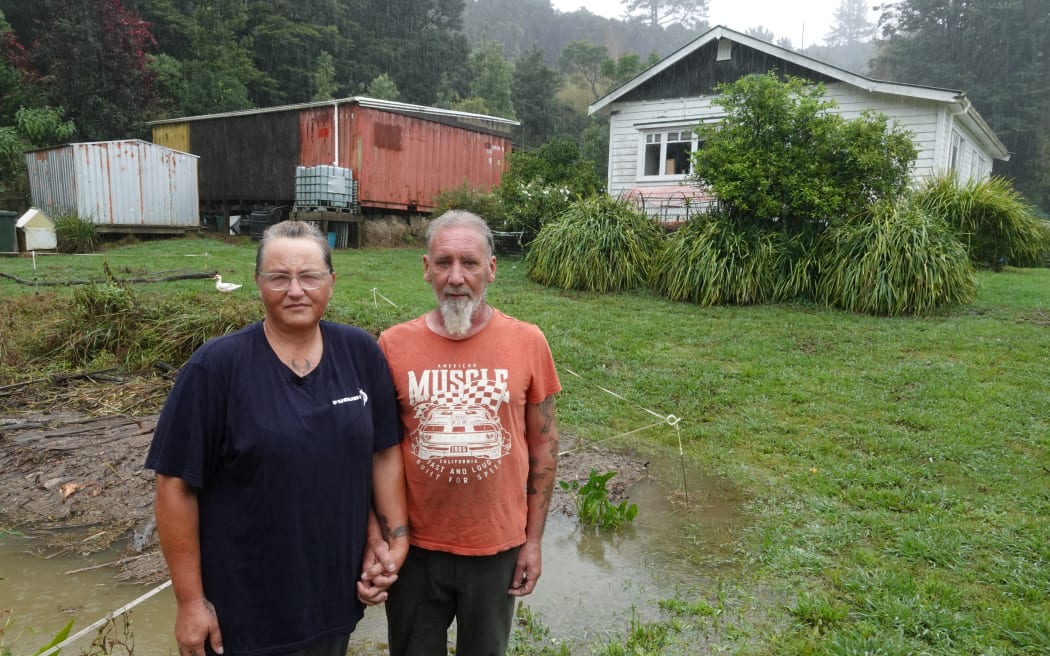 Kimberlee and Gary Whitehead at their home in the Far North’s Pupuke Valley as last week’s flood subsides.