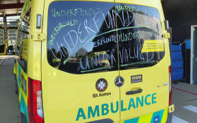 Hato Hone St John First Union members chalking ambulances with messages.