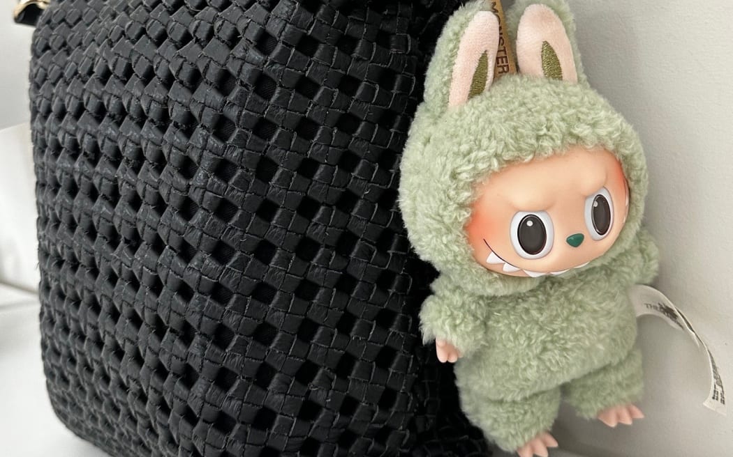 A collectible Labubu plush pendant on Jasmine Kim's handbag.