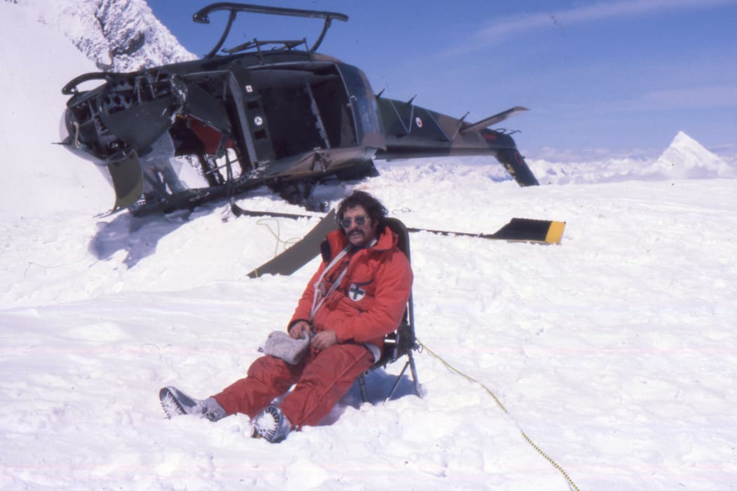A photo of Don Bogie with the crashed Iroquois helicopter at the Upper Empress Shelf on Mt Cook