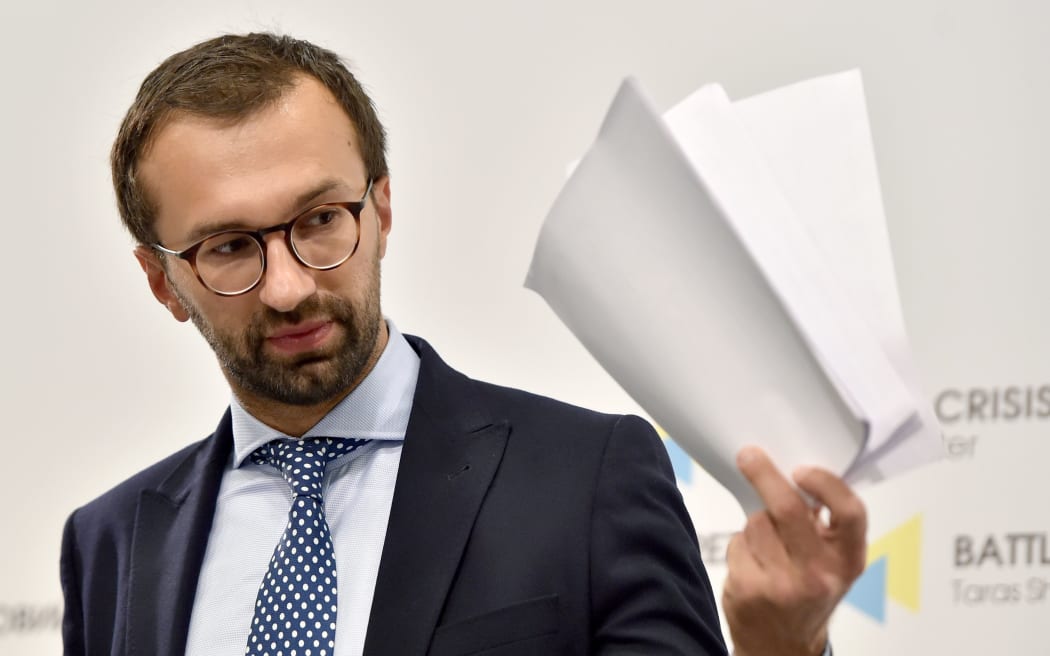 Ukrainian journalist and member of parliament Serhiy Leshchenko holds pages showing alleged signings of payments to Trump presidential campaign chairman Paul Manafort from an illegal shadow accounting book of former Ukrainian president Viktor Yanukovych's party