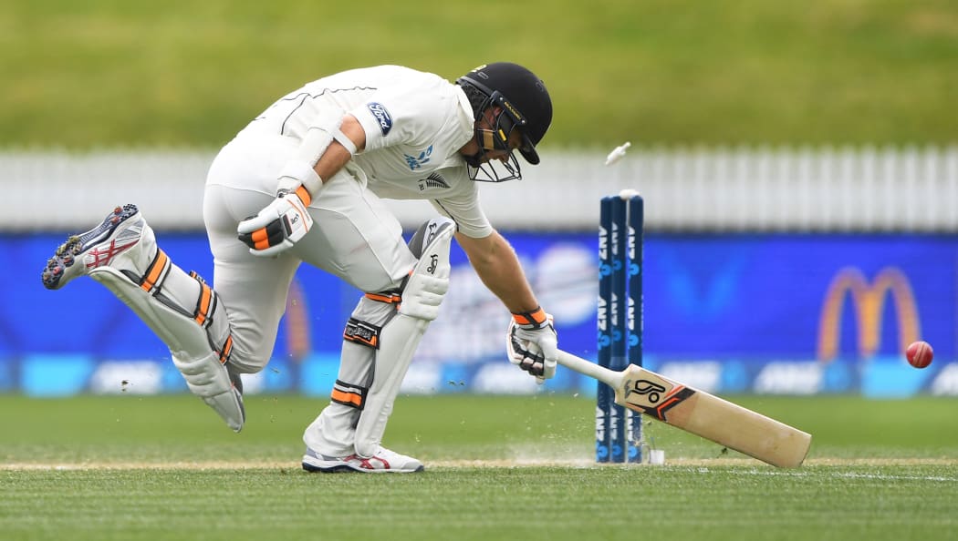 Tom Latham narrowly makes his ground.