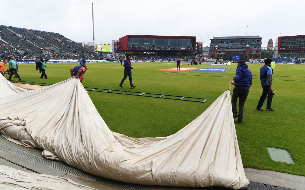 Rain covers heading out to cover the pitch.
New Zealand Black Caps v India. ICC Cricket World Cup semi final match. Old Trafford Cricket ground, Manchester UK. T