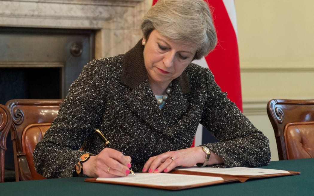 UK Prime Minister Theresa May signs the letter that will trigger Brexit.