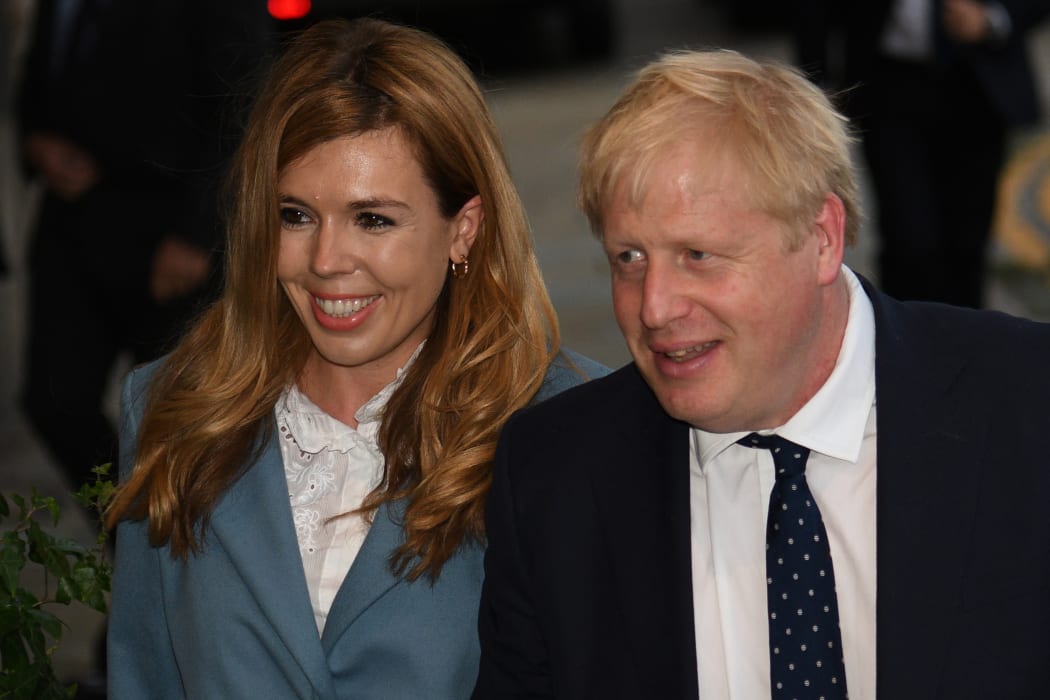 In this file photo taken on September 28, 2019 Britain's Prime Minister Boris Johnson walks with his partner Carrie Symonds.