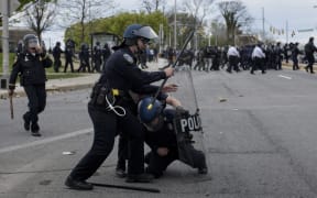 Police officers clash with protesters