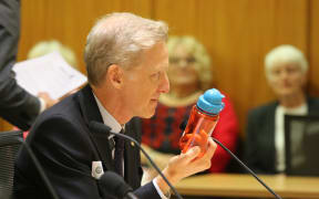 Grant Bayldon, Executive Director of Amnesty International NZ, demonstrates the size of a cluster bomblet
