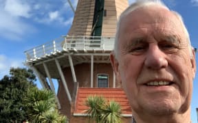John Girling in front of the Foxton windmill - a working replica of a Dutch 17th century flour mill.