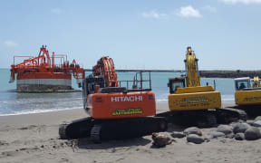 Three diggers and two tug boats were used to refloat the 250 tonne buoy.