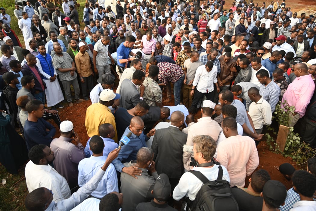 Relatives and mourners bury the body of Feisal Ahmed Rashid, killed the previous day in the attack on Nairobi luxury hotel complex DusitD2.