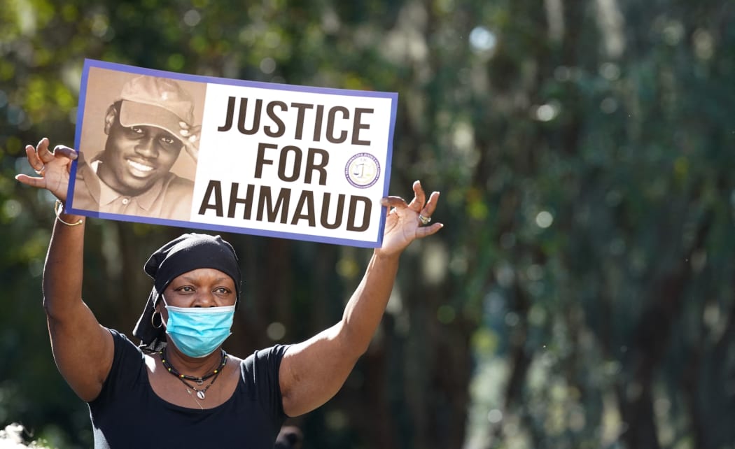 BRUNSWICK, GA - OCTOBER 18: Beverly Green, with the Transformative Justice Coalition, demonstrates at the Glynn County Courthouse as jury selection begins for the trial of the shooting death of Ahmaud Arbery on October 18, 2021 in Brunswick, Georgia.