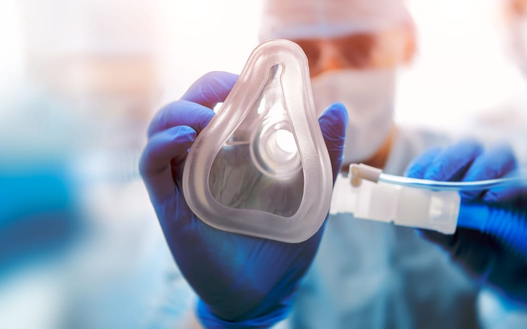 An anaesthetist giving a patient gas in a hospital