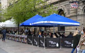 Customers sit at outside tables at a re-opened TGI Fridays restaurant in Glasgow.