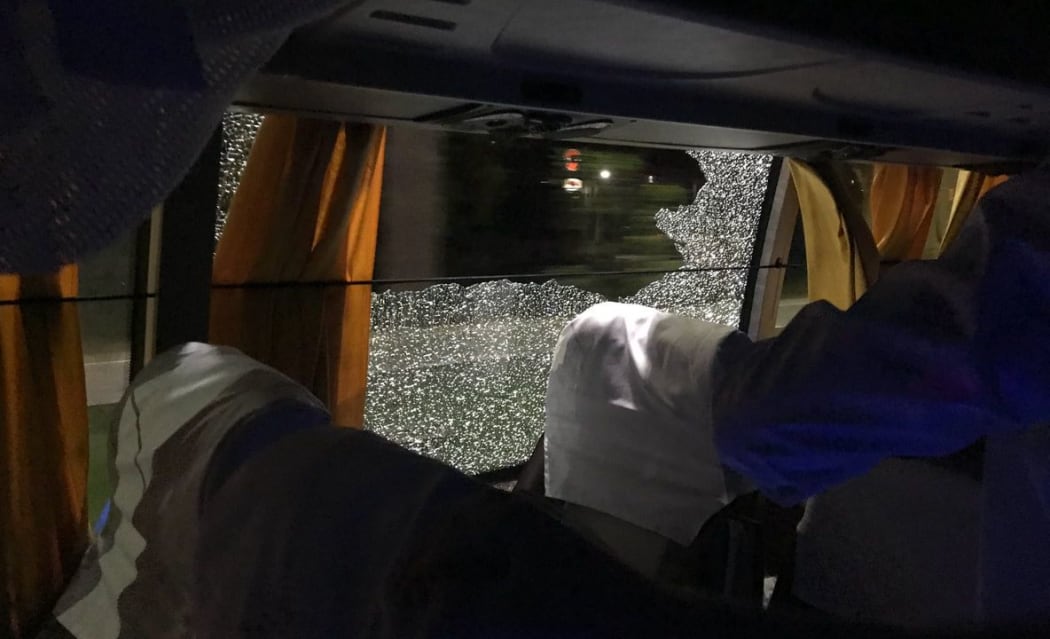 Australian team bus has window smashed by rock.