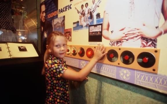 The 'Sounds Pacific' Interactive display, which featured the Isa Lei song, with Te Papa visitor Isabella Smith-Tinirau.