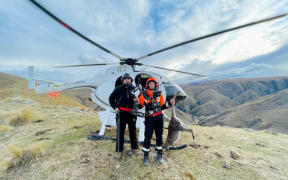 Contractors from Heliventures and thermal imagery operator Trap and Trigger with the wallaby killed in the Kakanui Mountains.