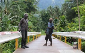Chief Maia Tonjo (left) led his community in building a 67-metre bridge over the Tupukas River in Arawa, Bougainville.