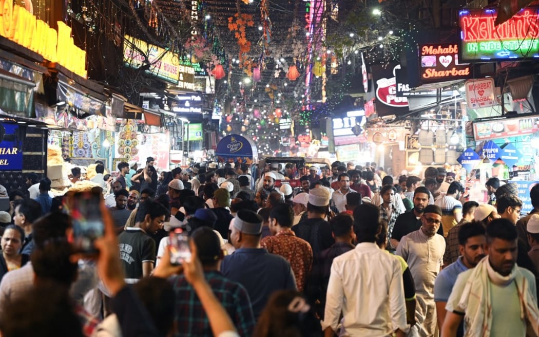 People throng a street near the Jama Masjid in the old quarters of New Delhi on April 19, 2023. - India is set to overtake China as the world's most populous country by the end of June, UN estimates showed on April 19, 2023, posing huge challenges to a nation with creaking infrastructure and insufficient jobs for millions of young people. (Photo by Arun SANKAR / AFP)
