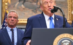 US President Donald Trump (R), alongside Secretary of Health and Human Services Robert F. Kennedy Jr. (L), speaks about autism in the Roosevelt Room of the White House in Washington, DC on September 22, 2025. (Photo by SAUL LOEB / AFP)