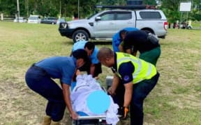 Fiji Navy and Health Ministry personnel help evacuate the New Zealand man to a hospital.