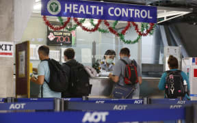 Foreign tourists queue at a health control counter at Suvarnabhumi airport, Thailand. The TAT is monitoring a viral outbreak in Chinas Hubei province.