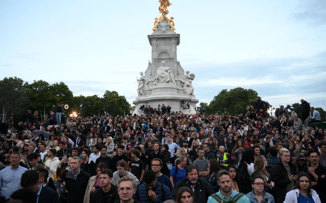People gather outside Buckingham Palace in central London after it was announced that Queen Elizabeth II has died, in central London on September 9, 2022.