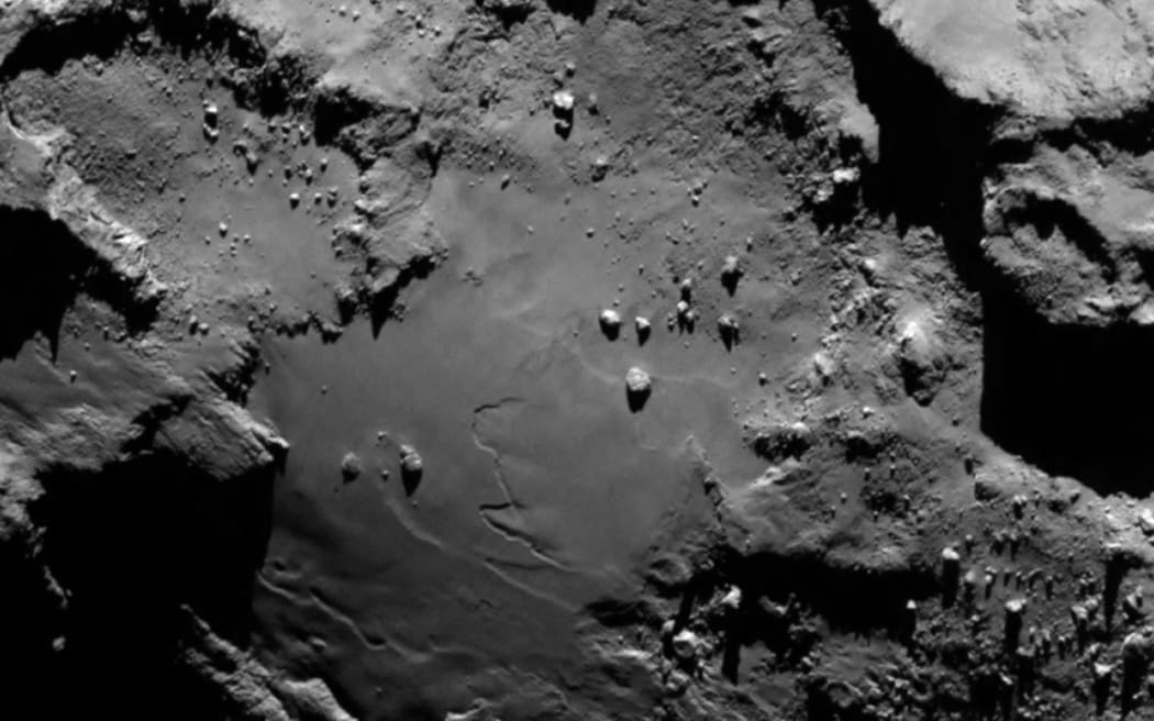 A close-up photo showing the smooth region on the "base" of the "body" section of comet 67P.