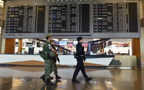 Armed military and police personnel patrol at Changi international airport terminal in Singapore on 30 January 2020.