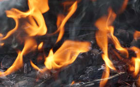 fire flame smoke embers to fry on the street close-up