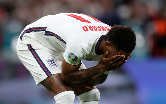 England's Marcus Rashford reacts after failing to score a penalty during a shootout at the end of the Euro 2020 football championship final.