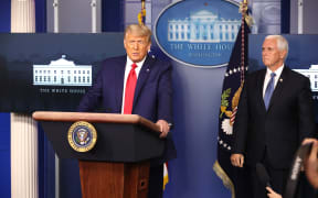US President Donald Trump (L) speaks as Vice President Mike Pence (R) looks on in the James Brady Press Briefing Room at the White House on November 24, 2020 in Washington, DC. Trump made brief remarks about the stock market hitting 30,000.