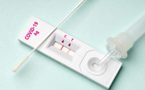Rapid test device for COVID-19 virus with a positive result.