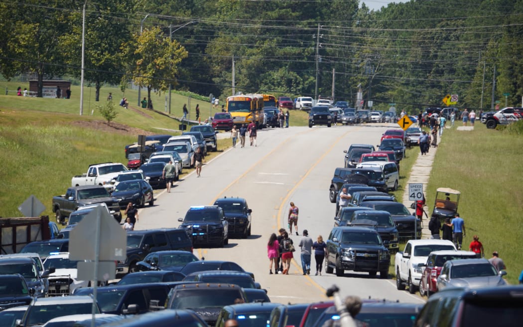 Cars line the road as parents arrive to meet students after a shooting at Apalachee High School on 4 September, 2024 in Winder, Georgia. Multiple fatalities and injuries have been reported and a suspect is in custody according to authorities.   Megan Varner/Getty Images/AFP (Photo by Megan Varner / GETTY IMAGES NORTH AMERICA / Getty Images via AFP)