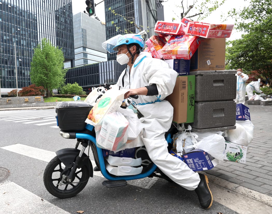 A delivery man from Jiangxi Province delivers goods in Shanghai, east China, April 15, 2022.