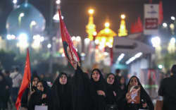 Mourners walk along a street as they arrive to attend the funeral of slain Iranian leader Ali Khamenei and members of his family near Imam Reza’s shrine in Mashhad early on July 9, 2026. Iranians were preparing on July 9 to bury their slain leader Ali Khamenei in his hometown of Mashhad in northeast Iran, as new US strikes threatened to trigger a fresh escalation in the Middle East war. The late supreme leader’s burial follows a multi-day funeral ceremony that attracted millions of mourners across various cities in both Iran and Iraq. (Photo by ATTA KENARE / AFP) /
