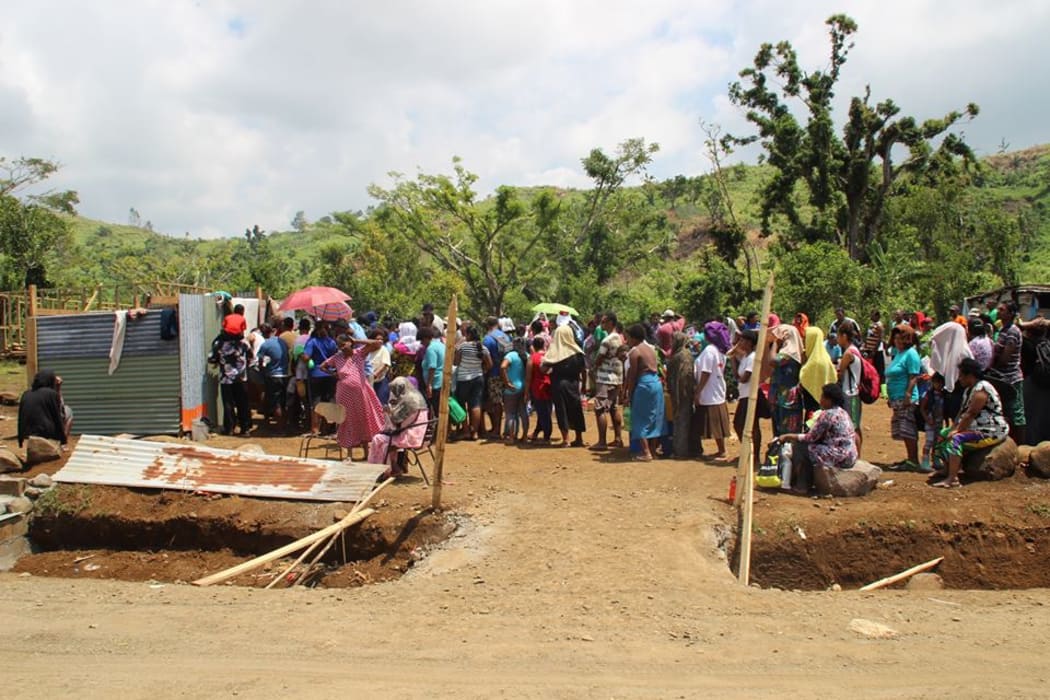 People queue to take bathe in the Natadradave stream's water said to hold healing properties.