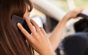 transportation and vehicle concept - woman using phone while driving the car