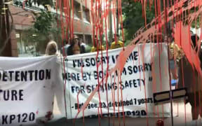 Protesters splashed red paint on windows and buildings at the University of Queensland, Australia
