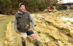 Michael Johnston at the riverbed site where preparations are being made to remove the the fossilised moa footprints he discovered.